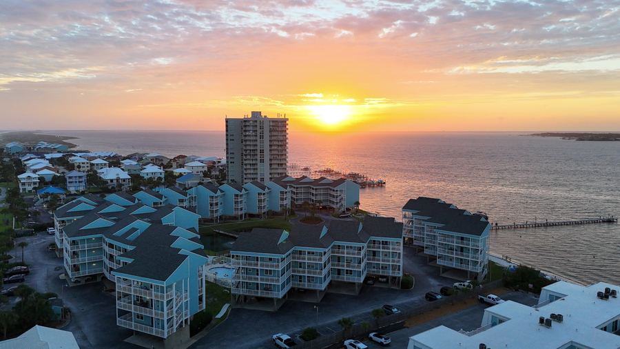Aerial sunset view of the condo complex and bay