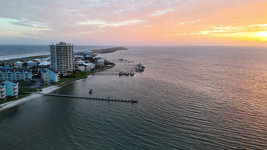Wide drone view of the bay and surrounding community