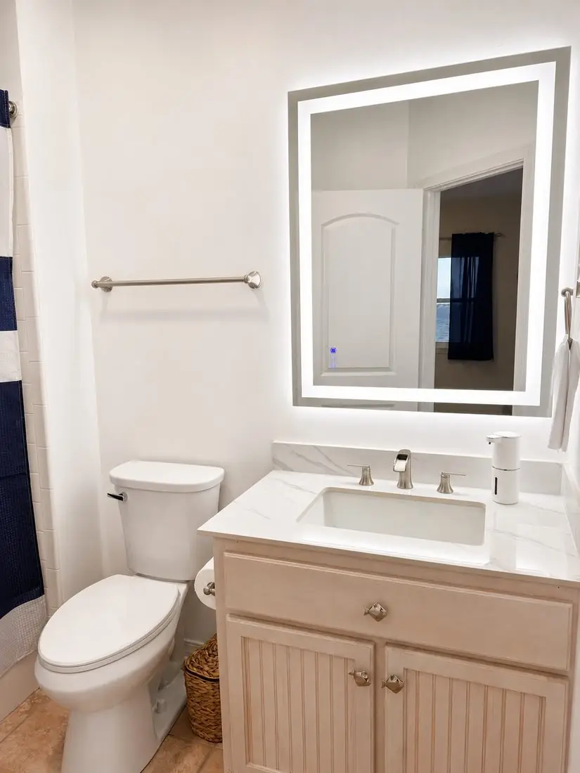 Modern bathroom with navy shower curtain and vanity
