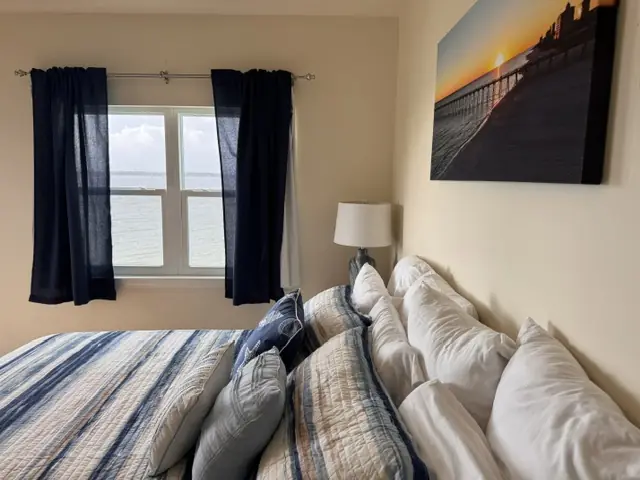 Primary bedroom with direct bay water views through the window