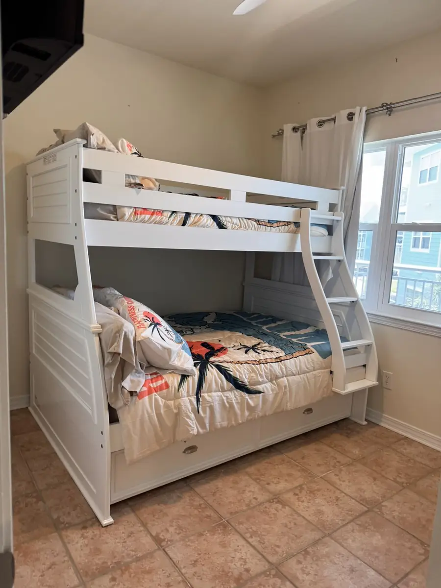 White twin over full bunk bed with coastal bedding and trundle drawer